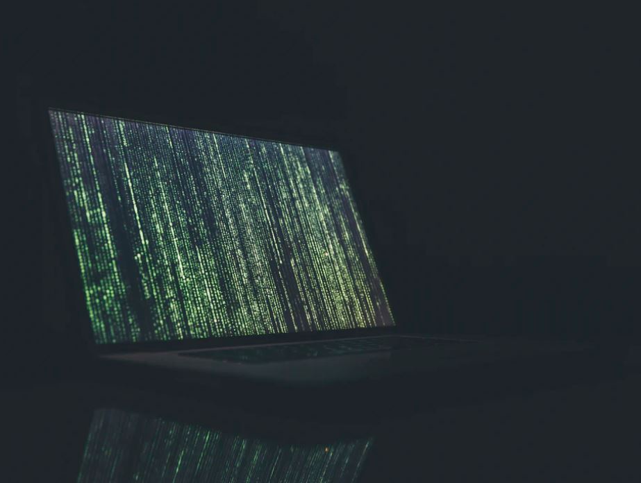 matrix-style laptop with text going down the screen, symbolising encryption